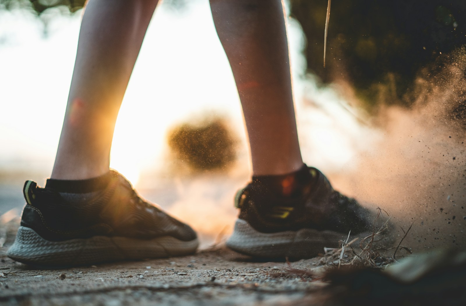shallow focus photo of person wearing black low-top sneakers